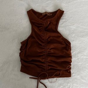 Rust orange sleeveless top with sheer back